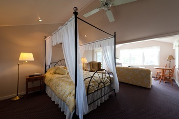 another canopy bed with a dark floor