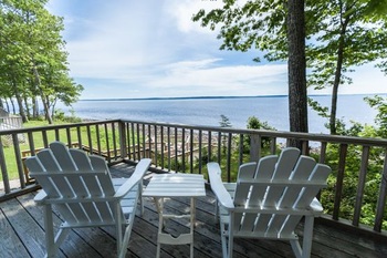 two white chairs viewing over the water