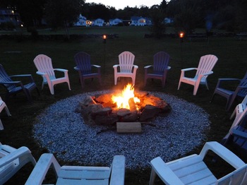 a fire pit with chairs surrounding it
