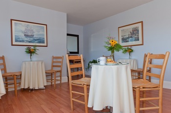 two tables with chairs in breakfast room