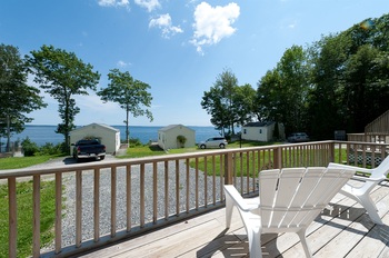 outside deck of oceanview cottage looking towards oceanview cottages and water