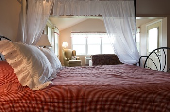 red comforter and white pillow