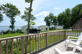 wooden front porch with a railing