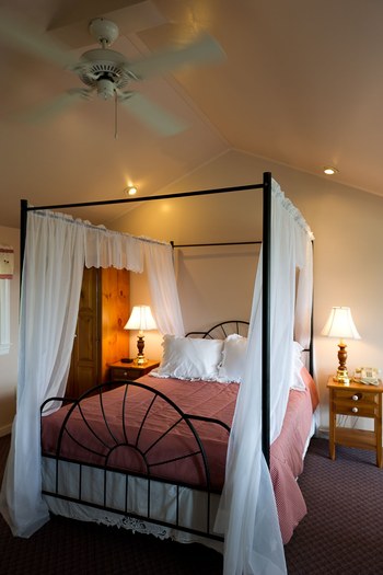 the canopy bed and a red comforter