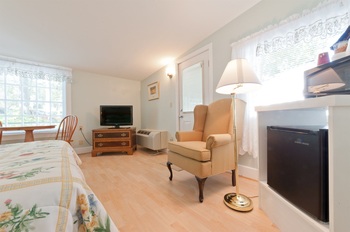 tan carpet and the tv in the corner with the couch