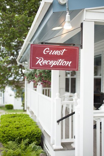side shot of the porch sign reads guest reception